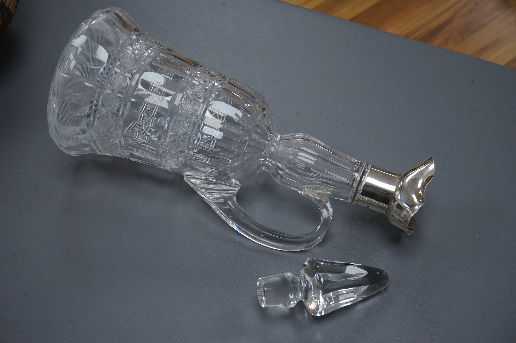 An Edwardian silver mounted cut glass bell shaped single handled decanter, with stopper, by Thomas Webb & Sons Ltd, London, 1902, 34.2cm.